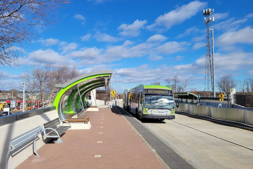Green and silver CTfastrak bus at a station in Elmwood, Connecticut.